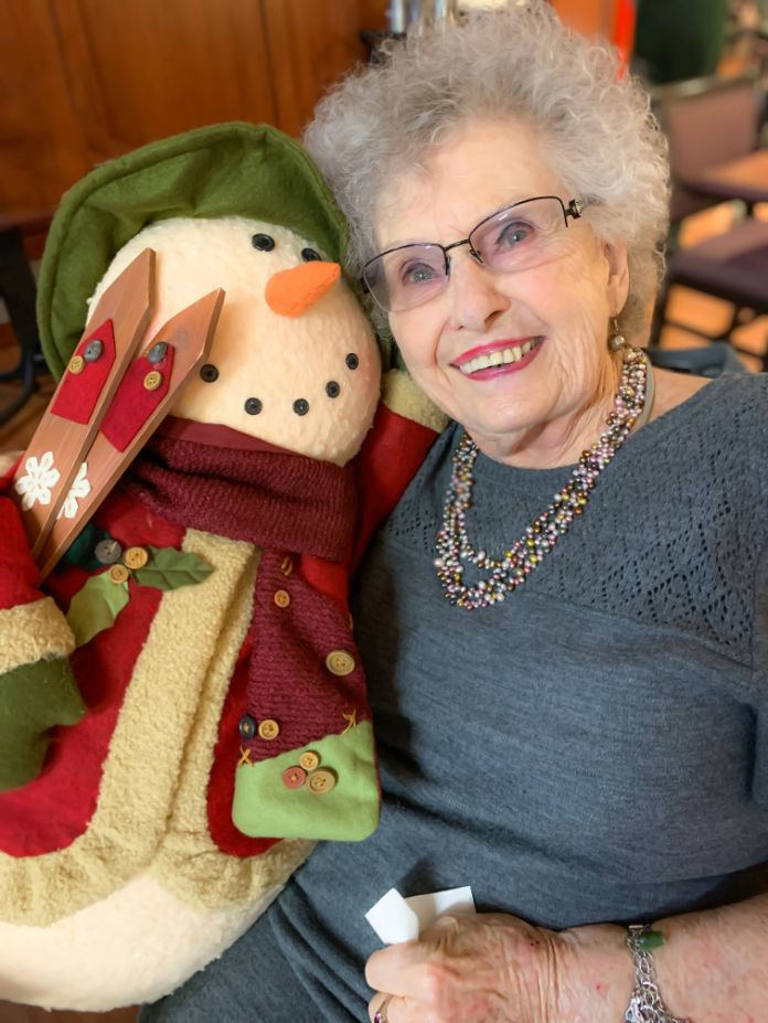 Elderly_lady_sitted_with_a_snowman